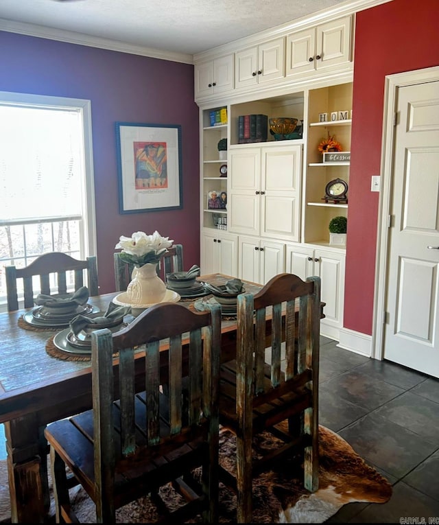 dining space featuring crown molding