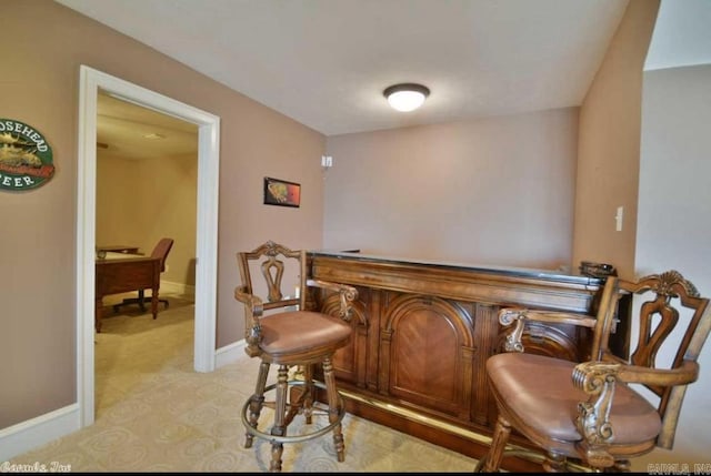 bar with light colored carpet and baseboards