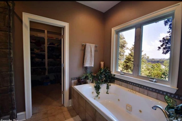 bathroom with a whirlpool tub and tile patterned floors