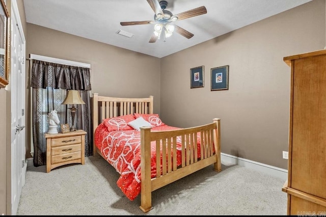 carpeted bedroom with a ceiling fan, visible vents, and baseboards