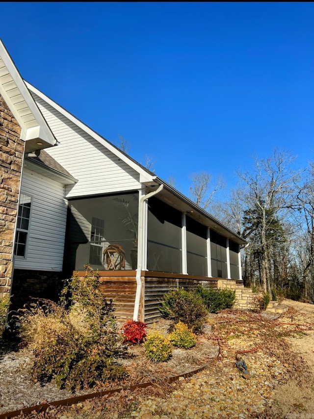 view of property exterior with stone siding