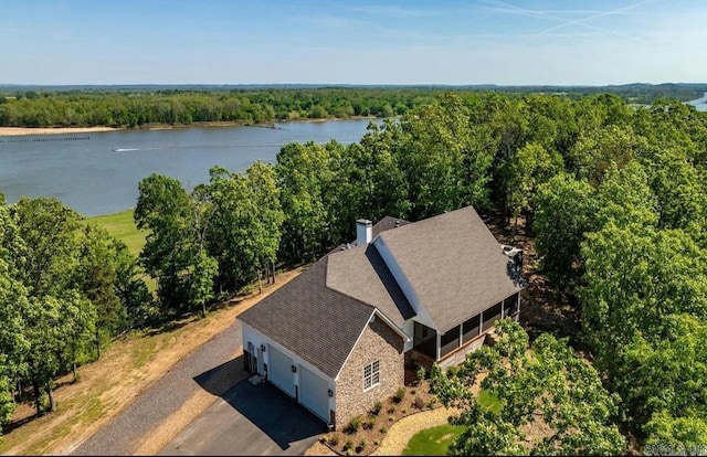 bird's eye view with a water view and a wooded view