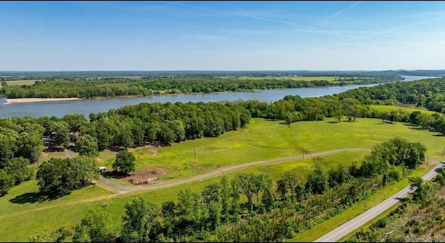 aerial view with a water view and a wooded view