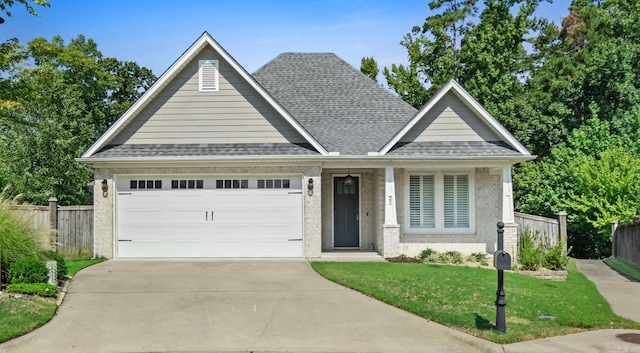 view of front of home with driveway, roof with shingles, an attached garage, fence, and brick siding