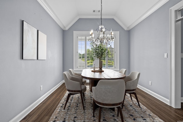 dining space featuring dark wood-type flooring, lofted ceiling, crown molding, and baseboards