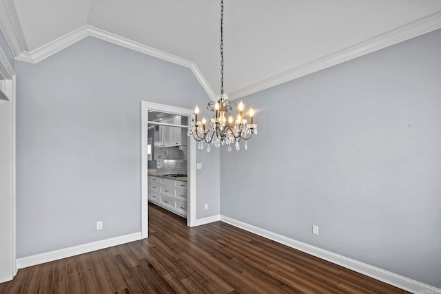 unfurnished dining area featuring dark wood-style flooring, crown molding, lofted ceiling, a chandelier, and baseboards