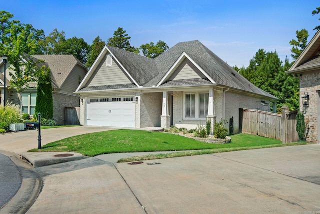 view of front of property featuring brick siding, concrete driveway, an attached garage, fence, and a front yard