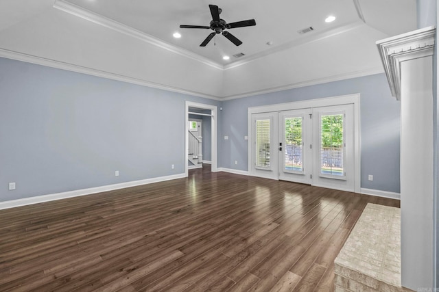 spare room with visible vents, baseboards, crown molding, and wood finished floors