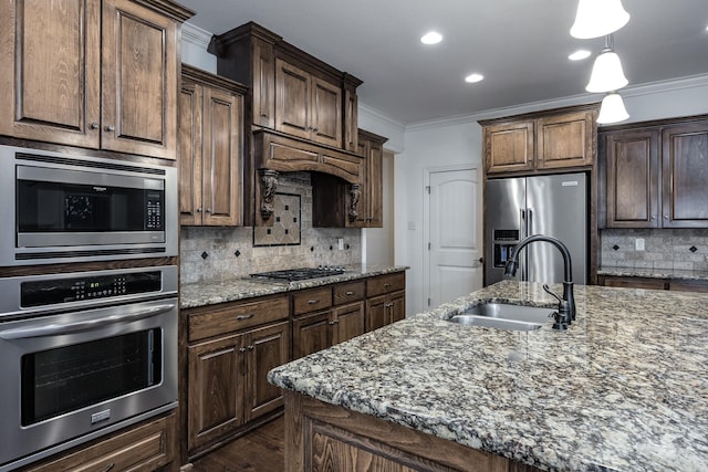 kitchen featuring stone counters, stainless steel appliances, backsplash, ornamental molding, and a sink