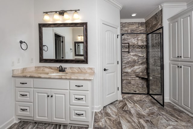 full bathroom featuring a stall shower, baseboards, ornamental molding, marble finish floor, and vanity