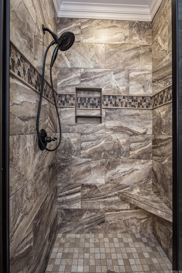 bathroom featuring a tile shower and crown molding