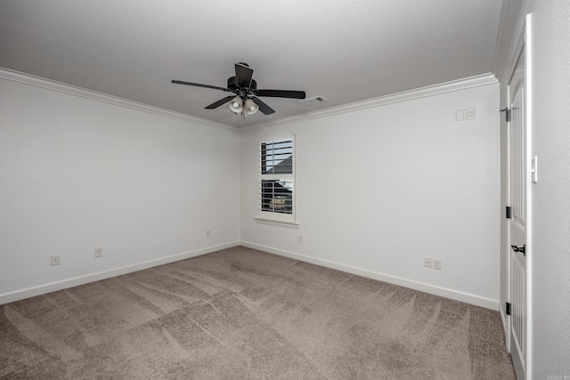 unfurnished room with visible vents, carpet flooring, a ceiling fan, and crown molding