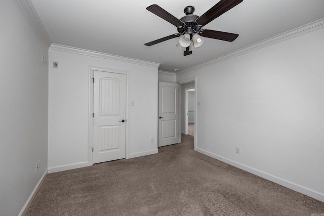 unfurnished bedroom featuring ceiling fan, carpet floors, ornamental molding, and baseboards