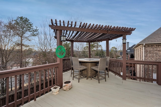 wooden terrace with outdoor dining space and a pergola