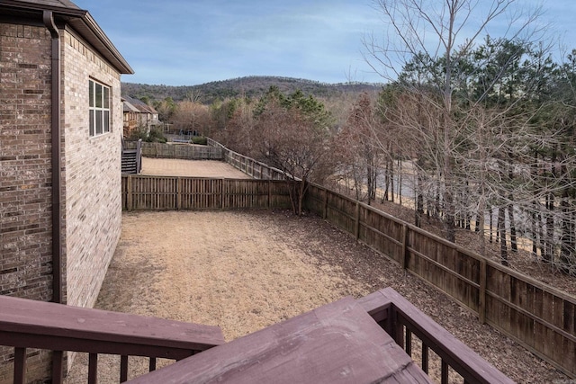 view of yard with a fenced backyard and a mountain view