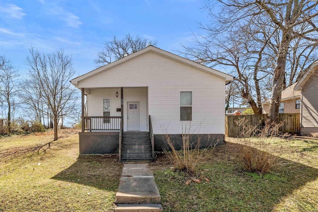 bungalow-style home with covered porch and fence