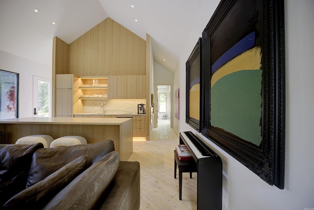 interior space with high vaulted ceiling and light wood finished floors