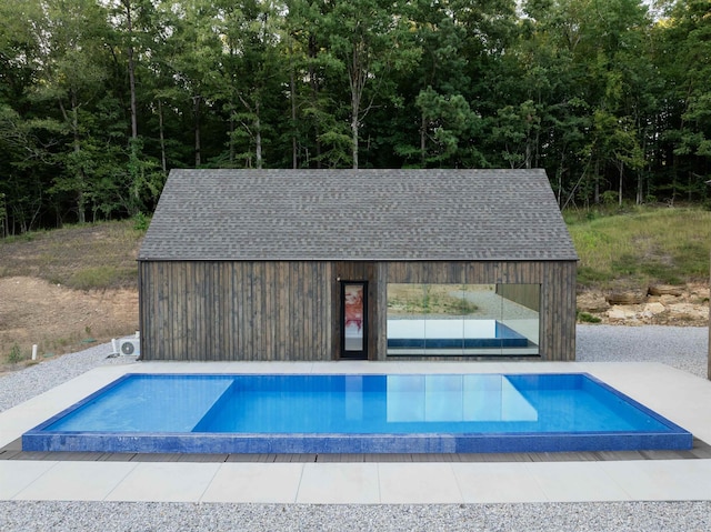 pool featuring an outdoor structure