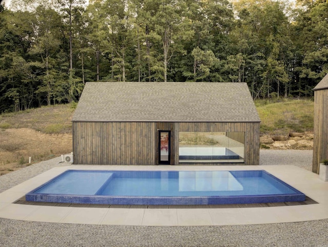 view of pool with an outdoor structure