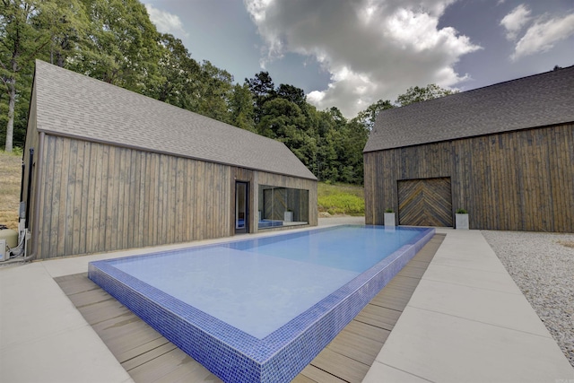 view of swimming pool featuring an outdoor structure