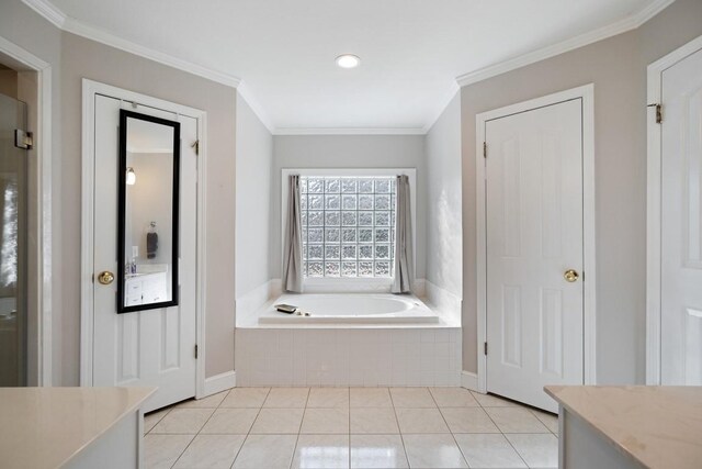 full bath with a garden tub, tile patterned flooring, vanity, baseboards, and crown molding