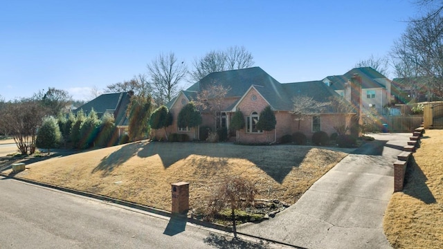 view of front of home featuring a chimney and fence