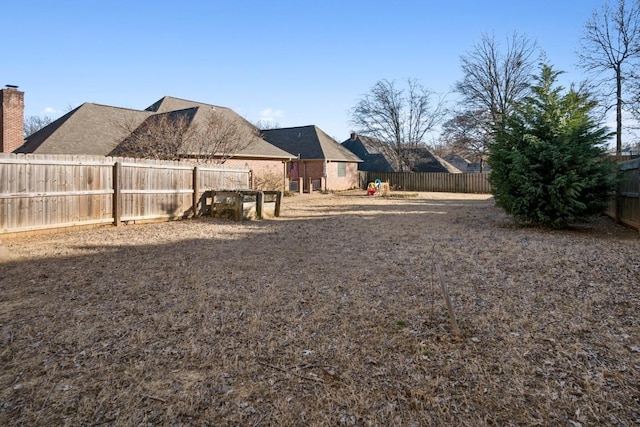 view of yard with a fenced backyard