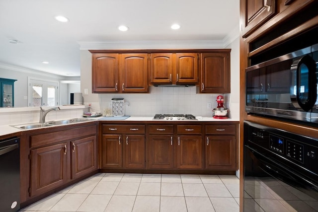 kitchen featuring stainless steel appliances, backsplash, a sink, and crown molding