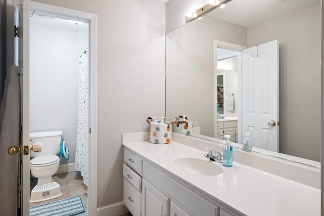 full bath featuring tile patterned flooring, baseboards, vanity, and toilet