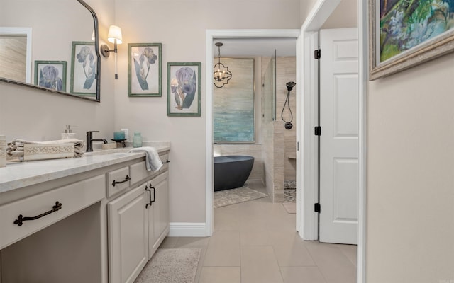 bathroom with baseboards, tiled shower, a soaking tub, tile patterned flooring, and vanity