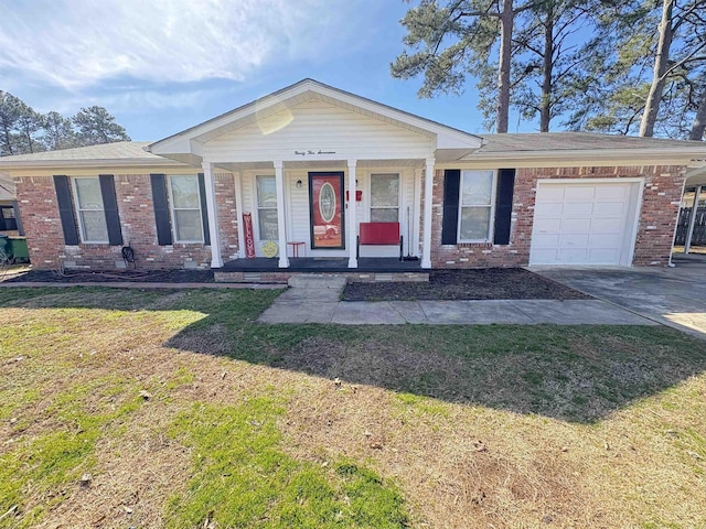 view of front of house with brick siding, concrete driveway, an attached garage, a porch, and a front yard