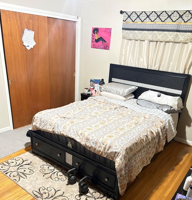 bedroom with baseboards and wood finished floors