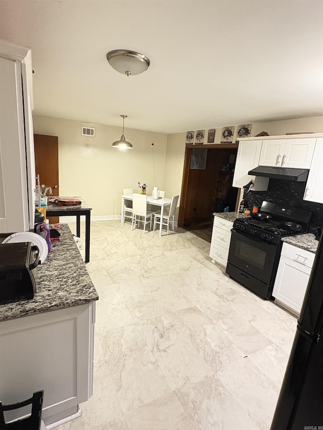 kitchen featuring under cabinet range hood, visible vents, white cabinets, and gas stove