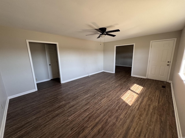 unfurnished bedroom with ceiling fan, baseboards, and dark wood-style flooring