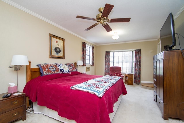 bedroom with ceiling fan, baseboards, crown molding, and light colored carpet