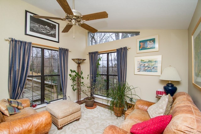 living area with ceiling fan and vaulted ceiling