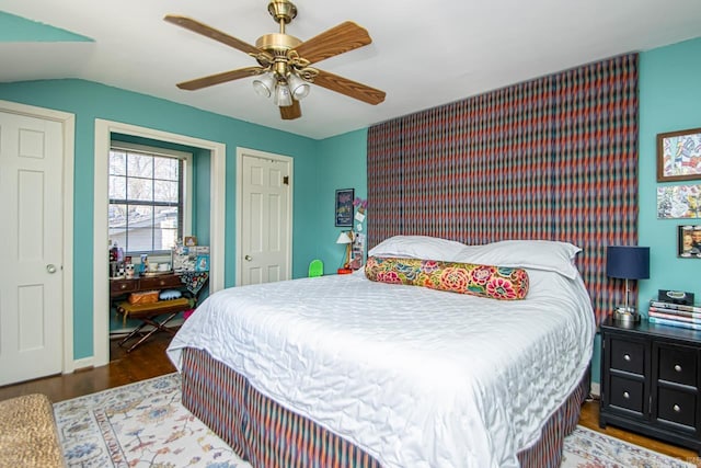 bedroom featuring ceiling fan, vaulted ceiling, and wood finished floors