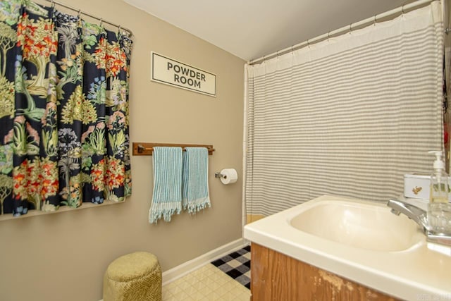 full bathroom with vanity, baseboards, and tile patterned floors