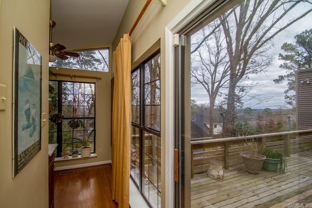 doorway featuring wood finished floors, visible vents, and a ceiling fan