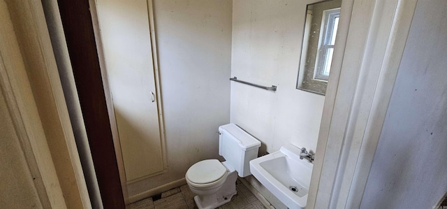 half bath with a sink and toilet