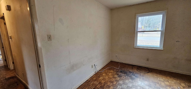 spare room with baseboards