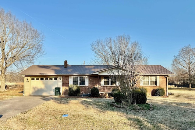 single story home with a garage, driveway, brick siding, and a chimney