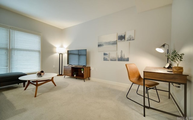 home office featuring light carpet and baseboards