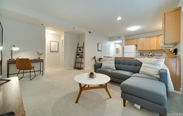 living area featuring light carpet, recessed lighting, visible vents, and baseboards