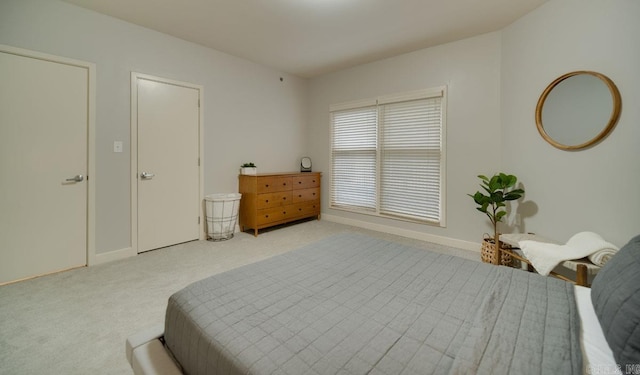 bedroom with carpet floors and baseboards