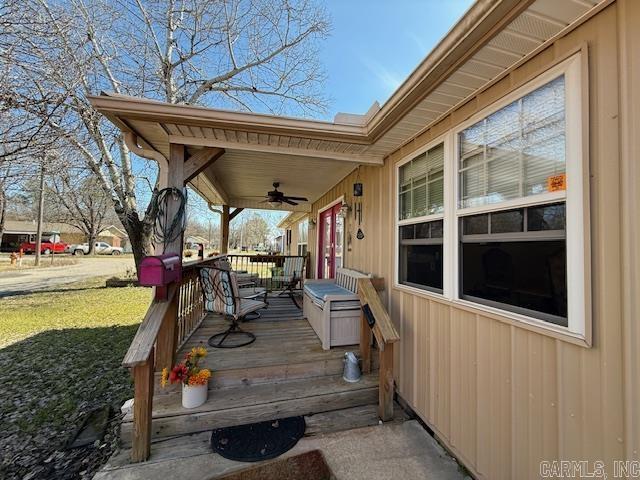 deck with a yard and a ceiling fan