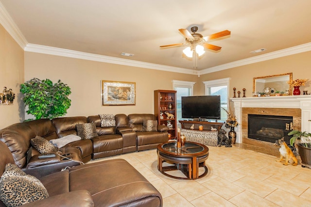 living room featuring a ceiling fan, visible vents, ornamental molding, and a premium fireplace