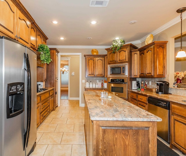 kitchen with stainless steel appliances, brown cabinets, visible vents, and a kitchen island