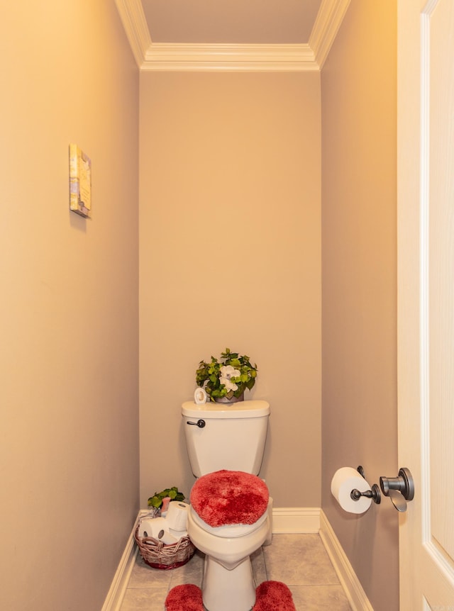 bathroom with toilet, tile patterned flooring, baseboards, and crown molding