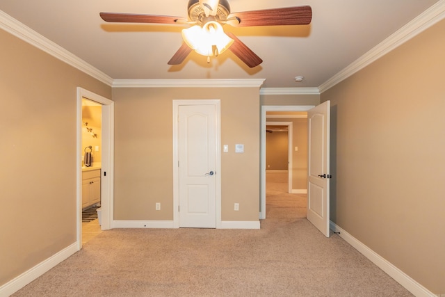 unfurnished bedroom featuring baseboards, connected bathroom, light colored carpet, ceiling fan, and ornamental molding